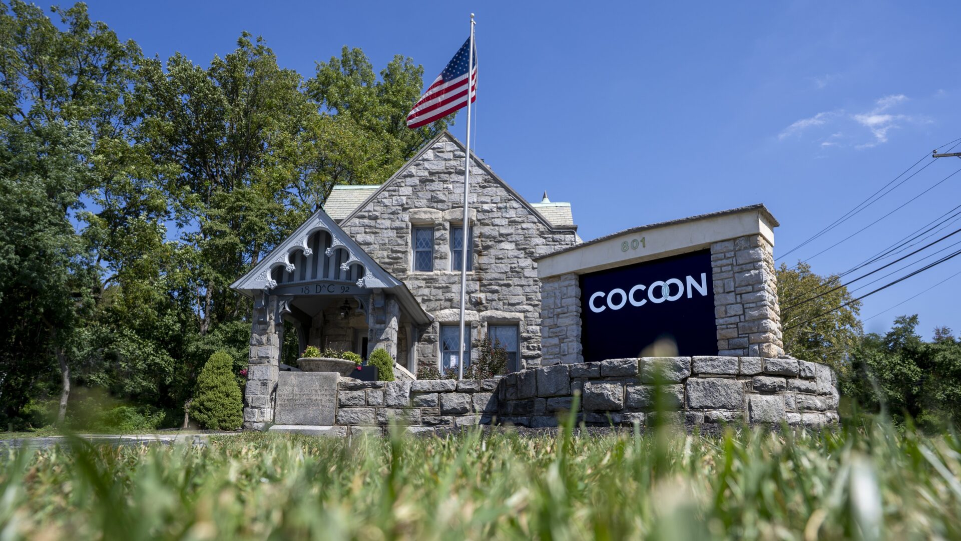 historical building with COCOON sign in front